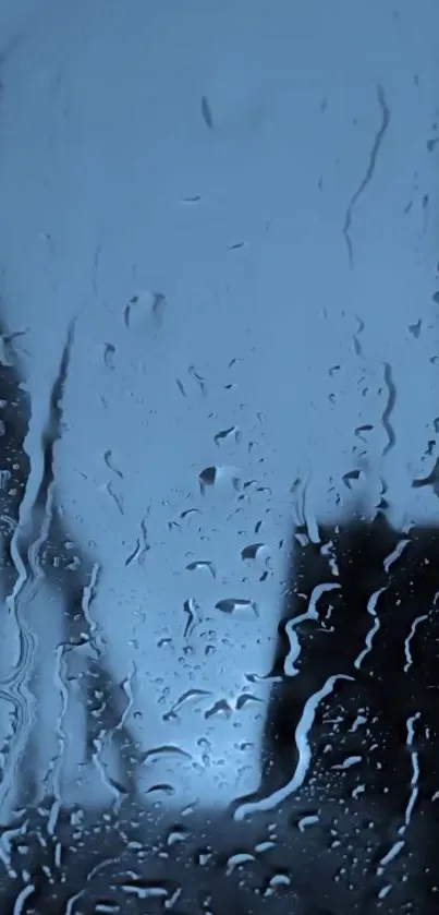 Raindrops on glass with blue background.