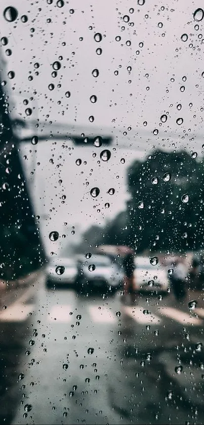 Raindrops on a window with an urban street scene in the background.