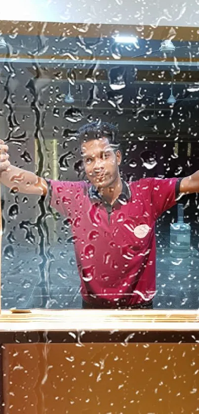 Mobile wallpaper with raindrops on a window and a person in a maroon shirt.