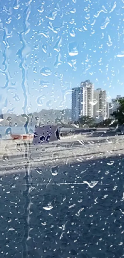 Raindrops on glass with beach and skyline in background.