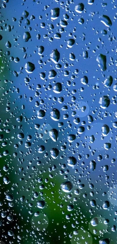 Raindrops on a window with a blue and green background, creating a serene effect.