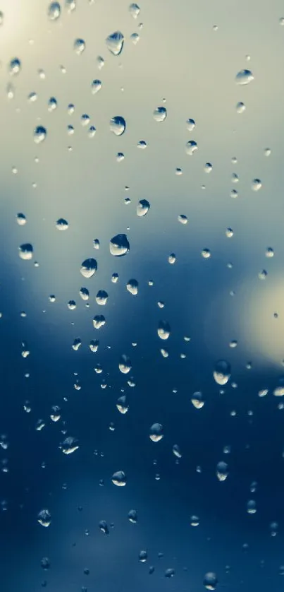 Raindrops on glass with a calming blue hue, perfect for a serene wallpaper.