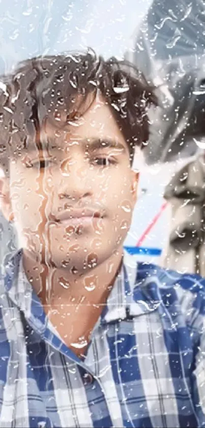 Portrait behind rain-drenched glass with a blue plaid shirt.