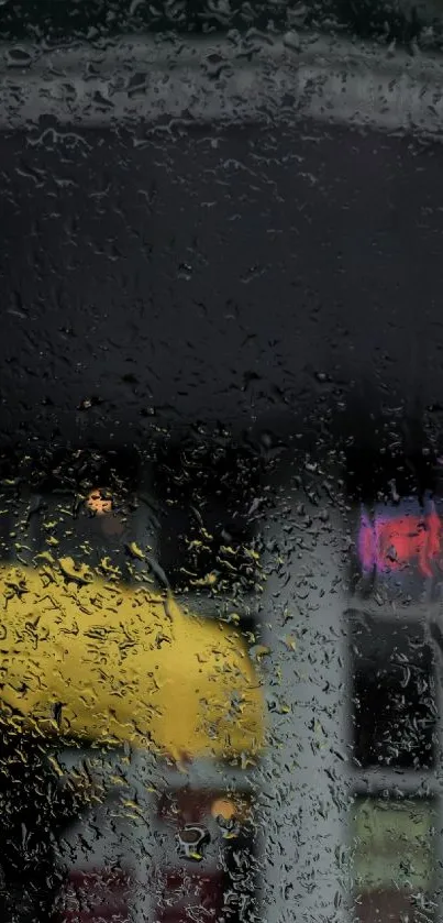 Blurred yellow umbrella seen through rain-streaked window glass.