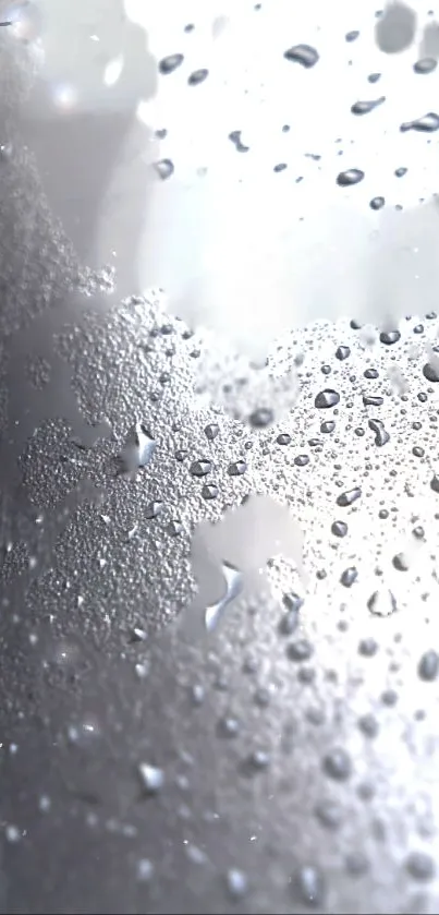 Mobile wallpaper with water droplets on glass surface in gray tones.