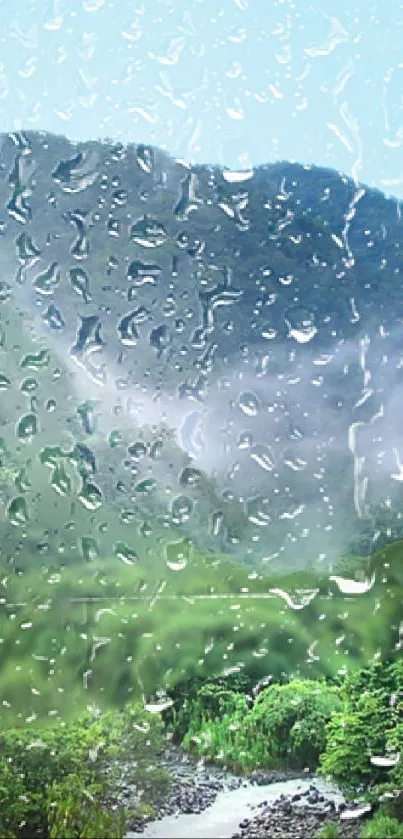 Rainy mountain landscape with lush greenery and misty hills, seen through raindrops.