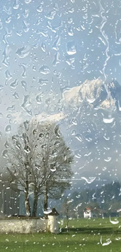 Raindrops on glass with mountain view and cloudy sky