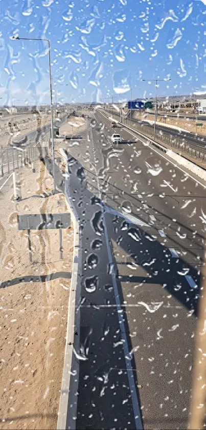 Rainy view of a desert road through a window.