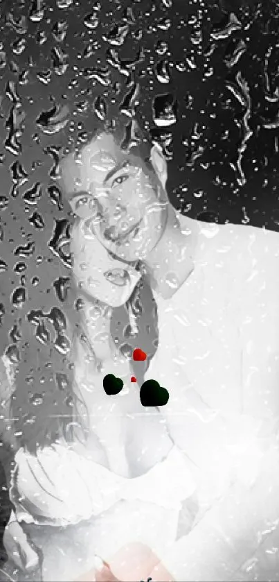 Romantic couple behind raindrop-covered glass in black and white tones.