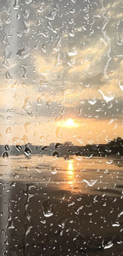 Rainy sunset beach view with raindrops on windowpane.