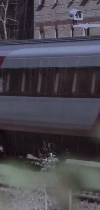 Train moving through rain with blurred natural foreground.