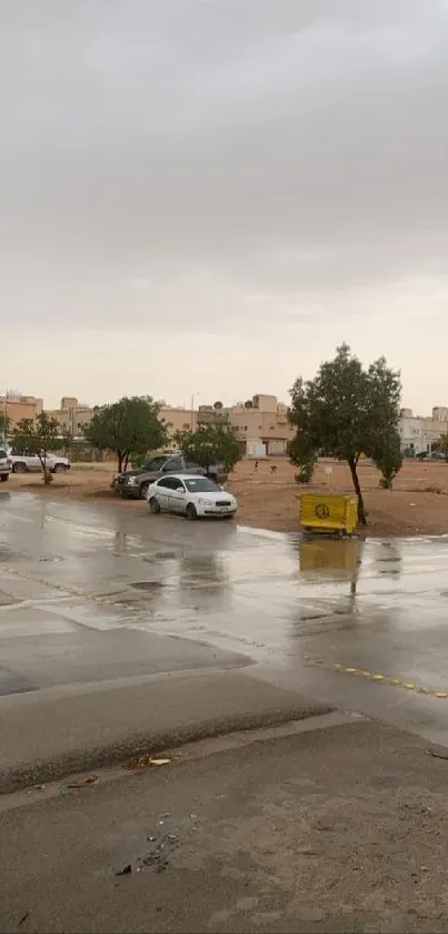 Rainy urban street with wet pavement and parked cars.