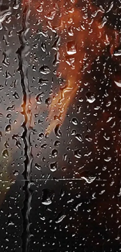 Abstract mobile wallpaper with raindrops and fiery orange hues on a window.