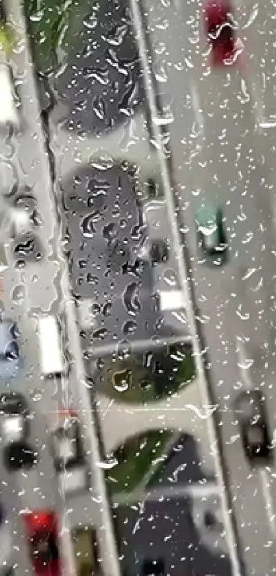 Raindrops on a window overlooking a city street with cars.