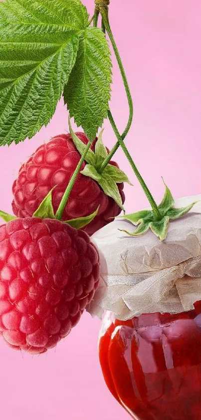 Raspberry and jam jar on a pink background with green leaves.