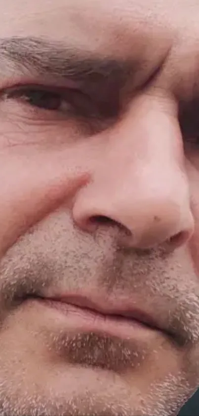 Close-up portrait of a serious man's face with soft tones.