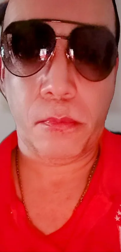 Portrait with sunglasses and red shirt on a mobile wallpaper.