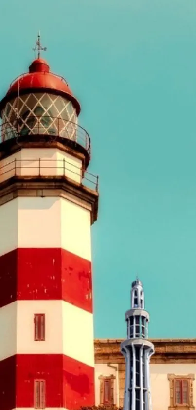 Red and white lighthouse with blue sky background.