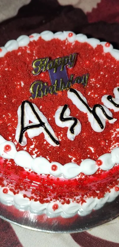 Red birthday cake with icing and 'Happy Birthday' text.