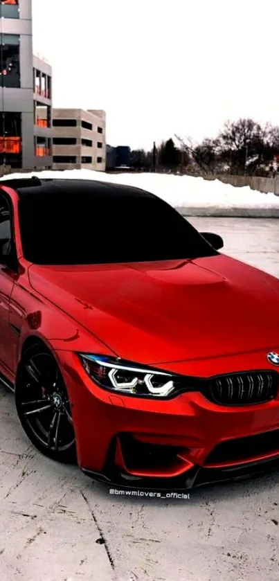 Red BMW sports car parked in urban setting on snowy day.