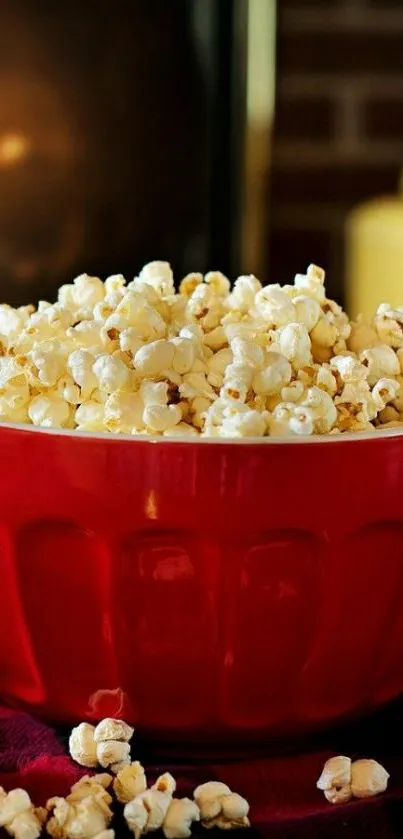 A red bowl filled with popcorn on a cozy setting.