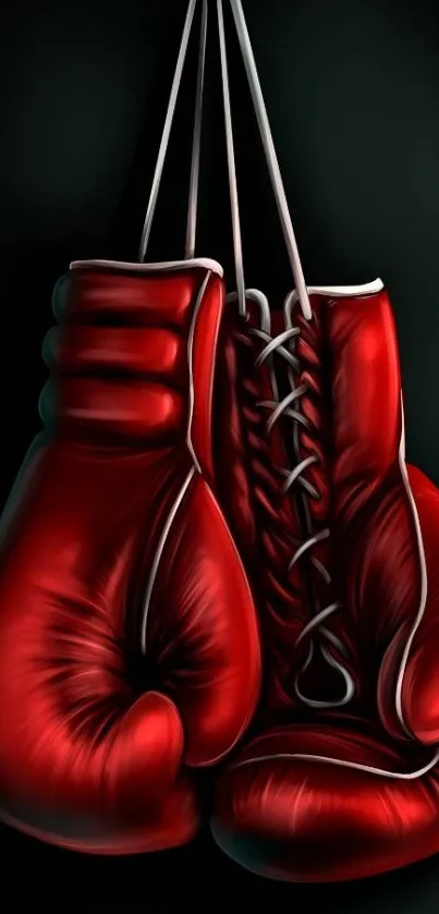 Red boxing gloves on a black background, hanging together.