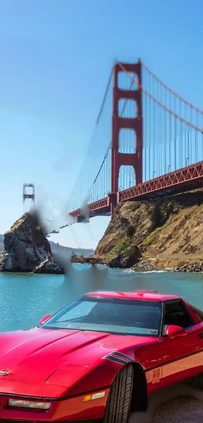 Red sports car by Golden Gate Bridge with blue sky.