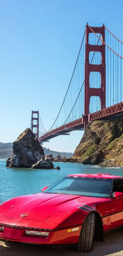 Red car parked by Golden Gate Bridge under a blue sky.