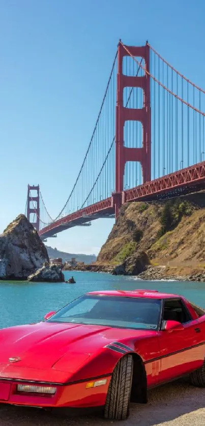 Red car parked by Golden Gate Bridge with clear blue sky.