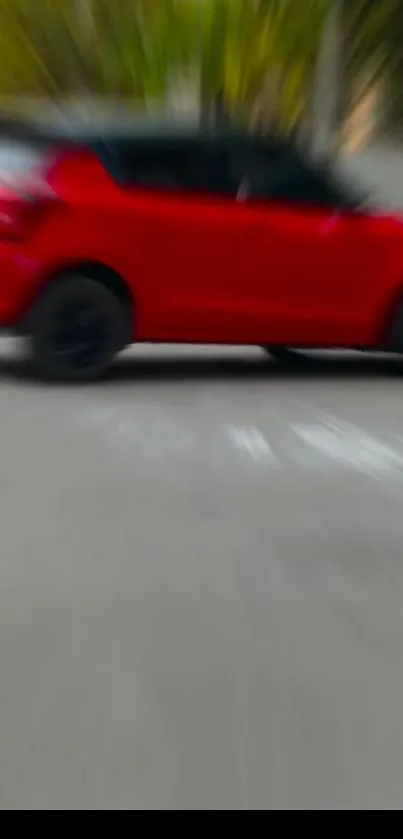 Blurred red car moving fast on road wallpaper.