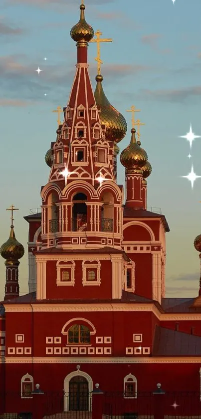 Red church with golden domes at sunset, serene landscape background.