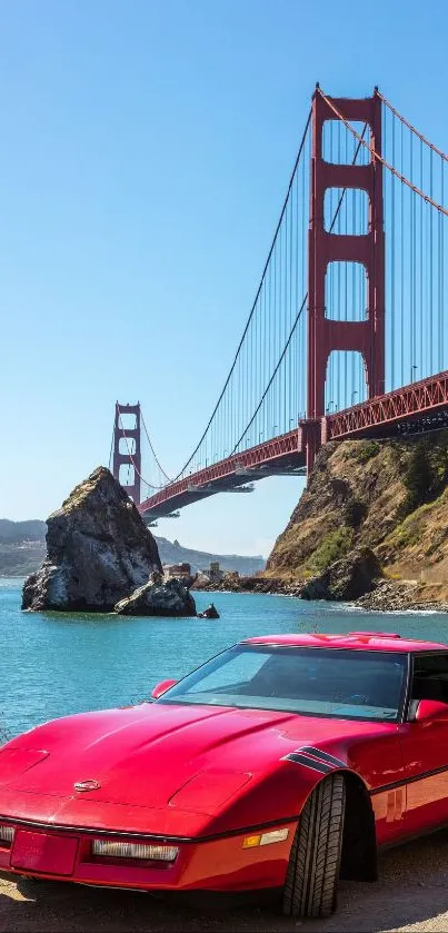 Red car parked by Golden Gate Bridge under clear blue sky.