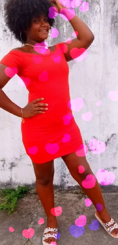 Woman in a red dress against a white rustic wall.