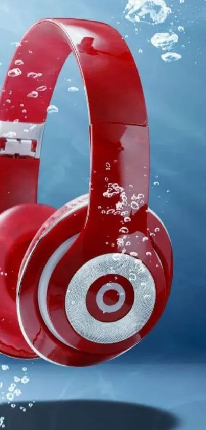 Red headphones submerged in water with air bubbles.