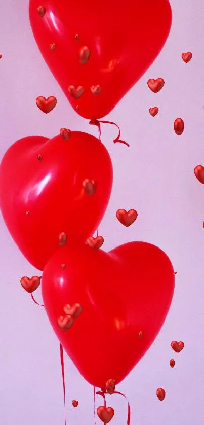 Three red heart-shaped balloons floating against a soft pink background.