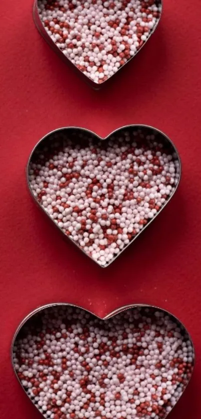 Heart-shaped candies on red background wallpaper.