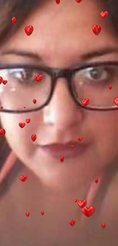 Close-up of a person with glasses surrounded by red hearts.