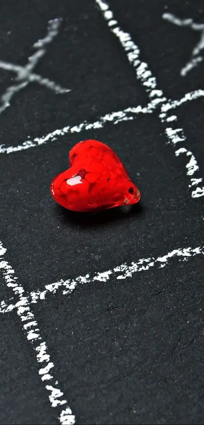 Red heart on a black chalkboard background with white markings.