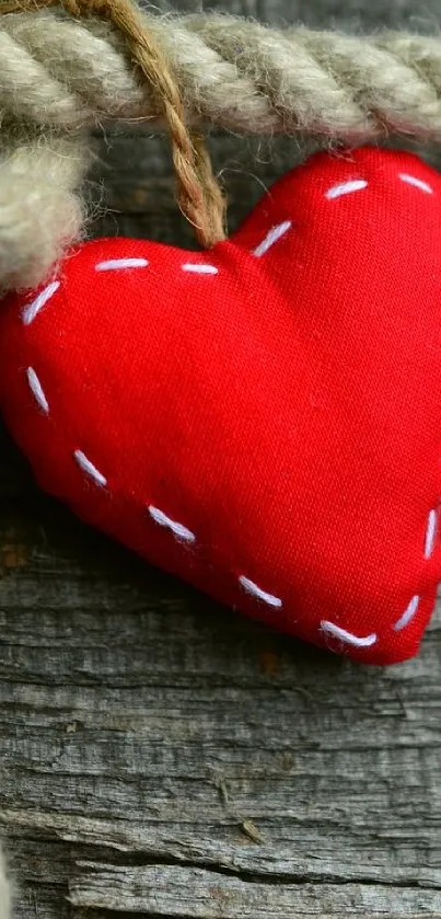 Red fabric heart on rustic rope background, mobile wallpaper.