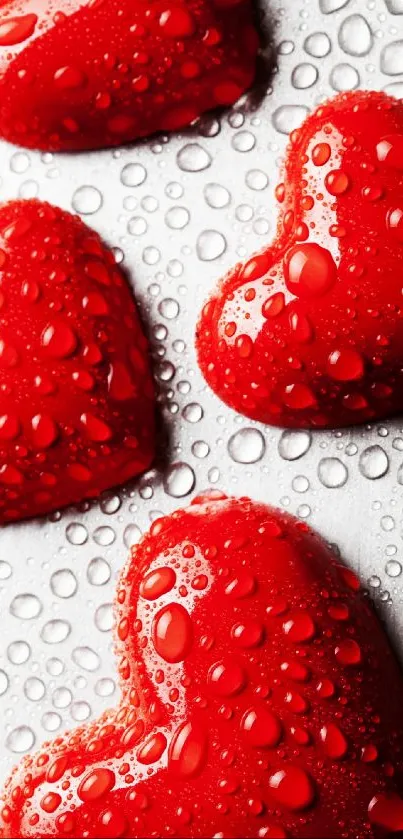 Red heart wallpaper with water droplets on silver background.