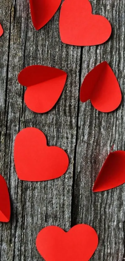 Red paper hearts on rustic wood background, mobile wallpaper.