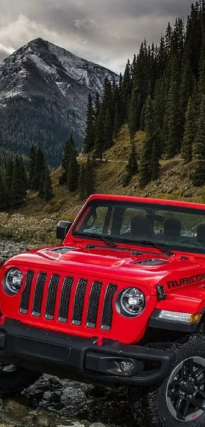 A red Jeep parked in a picturesque mountain landscape with a scenic forest backdrop.