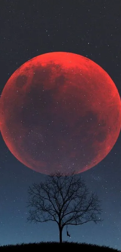 Silhouette tree against a red moon backdrop in a starry night sky.