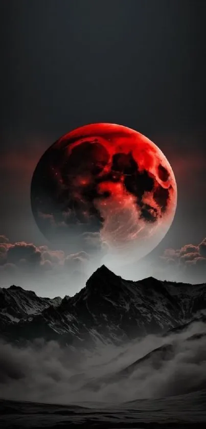 Stunning red moon over misty mountains and clouds, perfect for phone wallpaper.