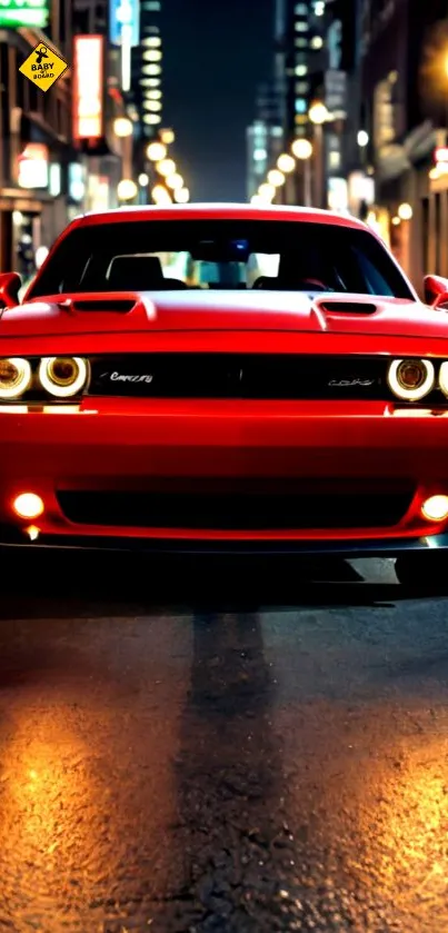 Front view of red muscle car at night on city street.