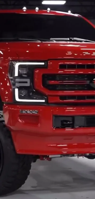 Red pickup truck with bold design and large wheels.