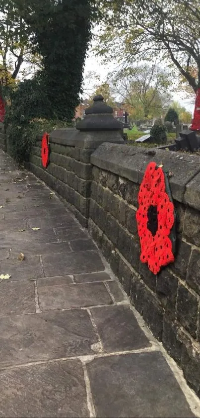 Stone path with red poppy flowers on the walls, under a canopy of trees.