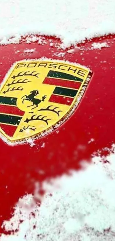 Red Porsche badge with snowy background.