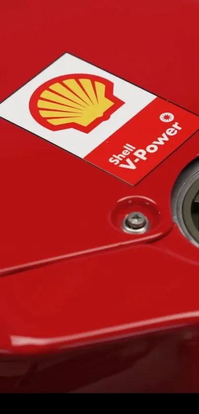 Red racing fuel tank with Shell V-Power logo, emphasizing vibrant design.