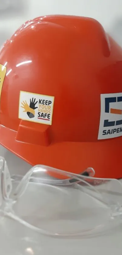 Red safety helmet and goggles on display.